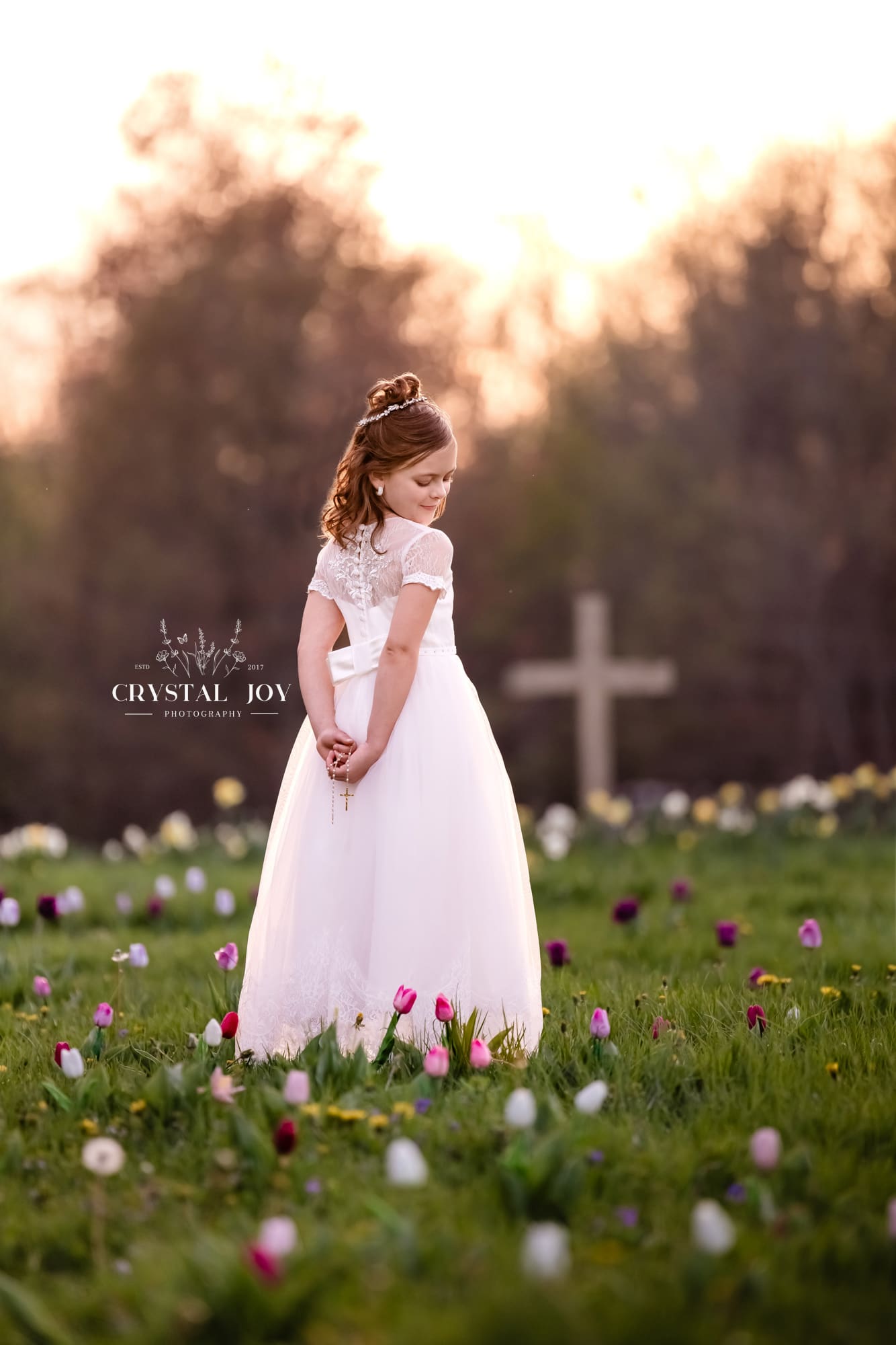 First Holy Communion in Flowers with Cross at Sunset